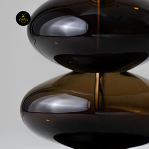 Close-up of Adam lamp upper glass body with glossy amber finish