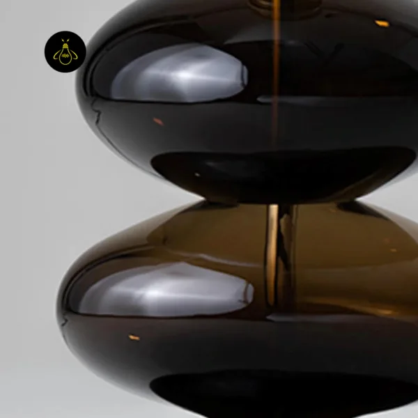 Side angle of glass table lamp showing the stacked amber borosilicate glass form