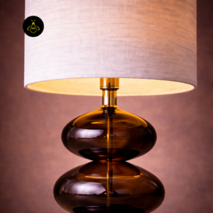 Close-up of Adam lamp fabric shade and warm amber glass body