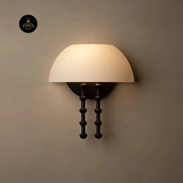 Front view of the alabaster dome wall light glowing on a plain wall, with round backplate and twin rods