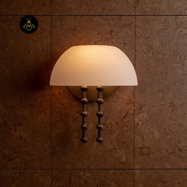 Alabaster dome wall light glowing on a dark textured tiled wall