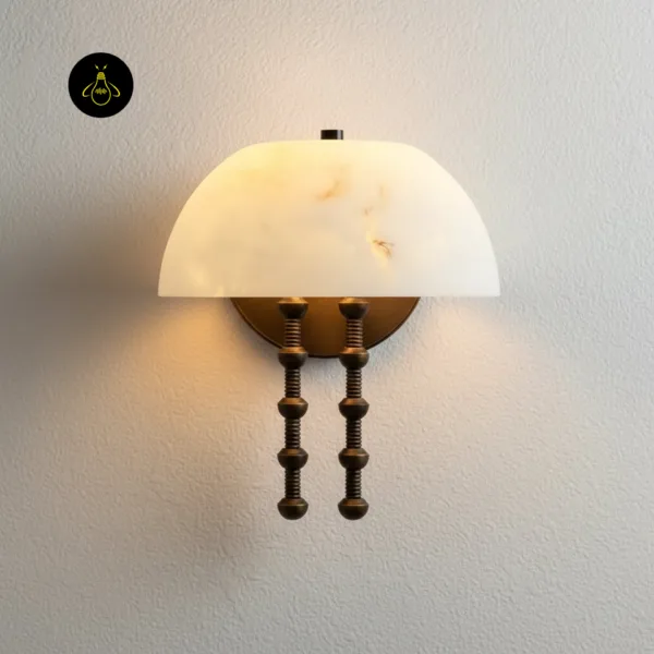 Alabaster dome wall light on a white textured wall, warm glow through the veined stone