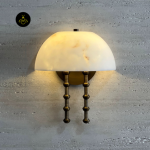 Modern wall sconce lit on a textured wall to show the warm alabaster glow