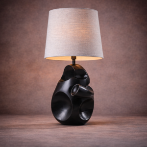 Asymmetrical table lamp hero view with sculptural dark wood base
