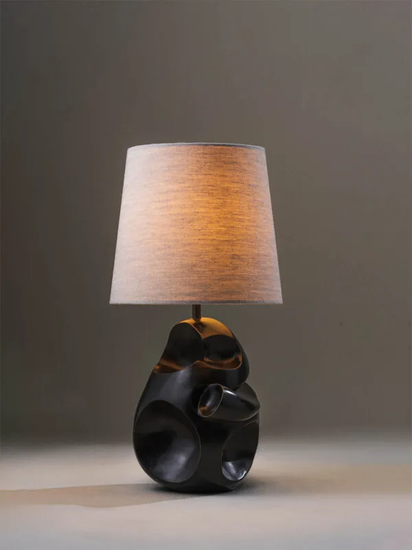 Modern sculptural table lamp styled in a contemporary interior with warm ambient light