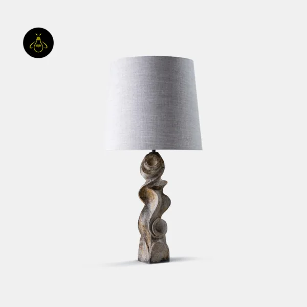 Sculptural table lamp with carved wood base and tapered linen shade