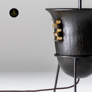 Close-up of living room table lamp showing textured dark wood finish and decorative side detail