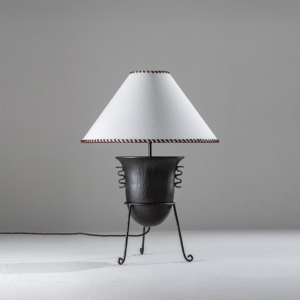 Living room table lamp with dark wood amphora-inspired base and fabric shade on a neutral background