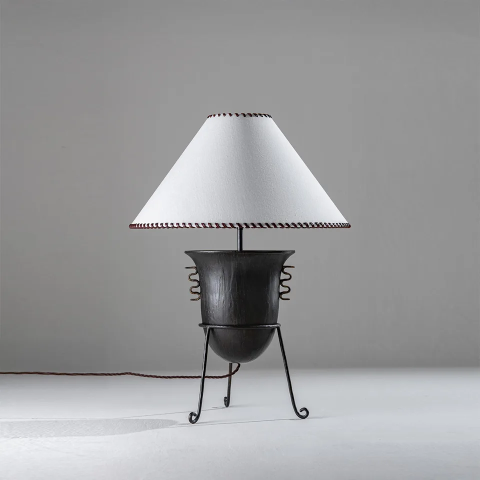 Sculptural wood table lamp with amphora vessel and oyster coolie shade for a living room console