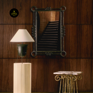 Living room table lamp placed beside a decorative mirror in a statement interior