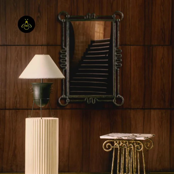 Tripod wood table lamp on a console beside a mirror in a statement living room