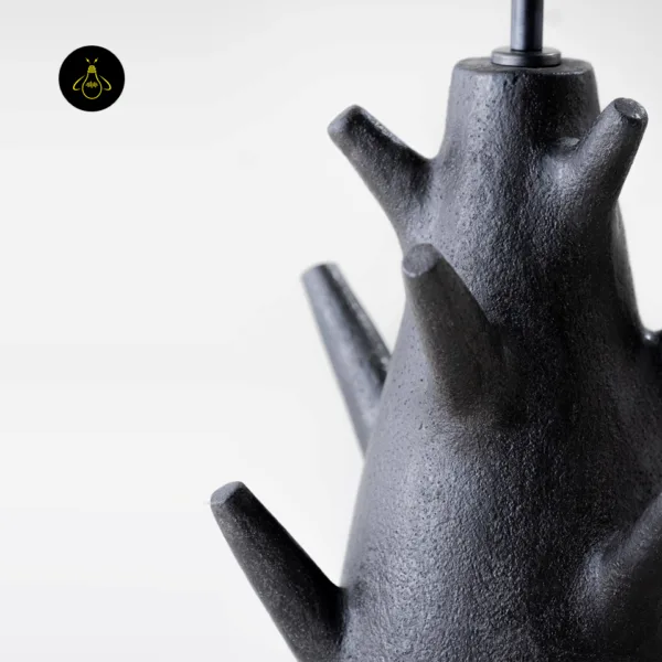 Detail of rustic table lamp handcrafted charcoal-black branch base
