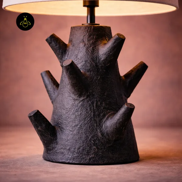 Close-up of rustic table lamp textured charcoal branch base with cut-branch detail