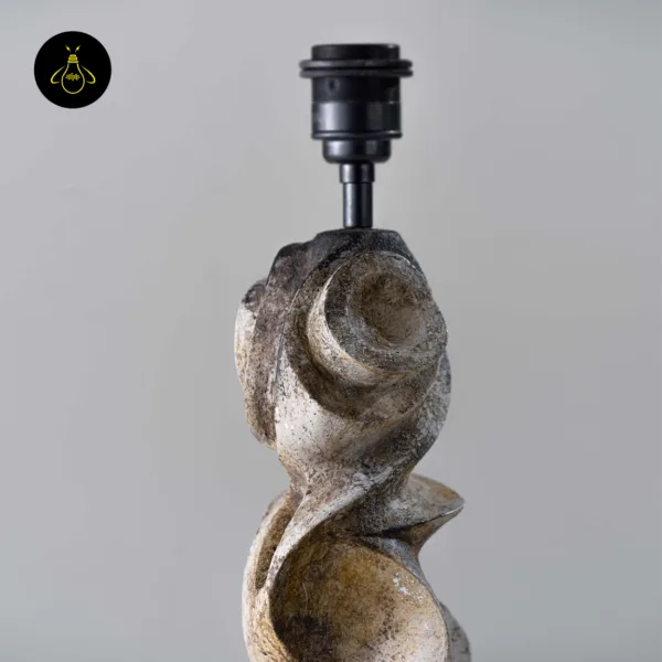 Close-up of sculptural table lamp carved wood base in distressed burnt finish