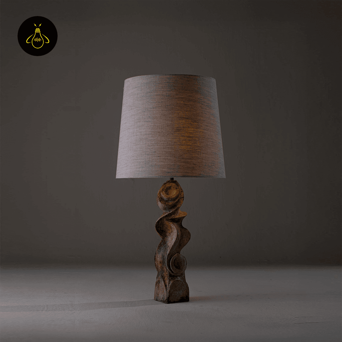 Sculptural Table Lamp – Carved Wood Base with Linen Shade, 72 cm 10 Carved wood sculptural table lamp lit with warm ambient glow through linen shade
