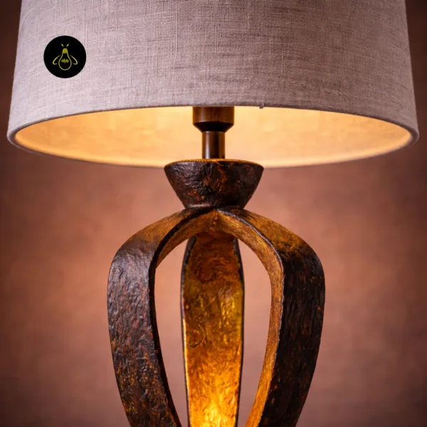 Detail of small bedroom table lamp natural linen shade and bronze lampholder