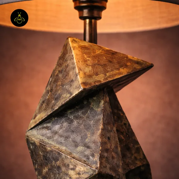 Close-up of geometric table lamp upper origami-folded wood facets