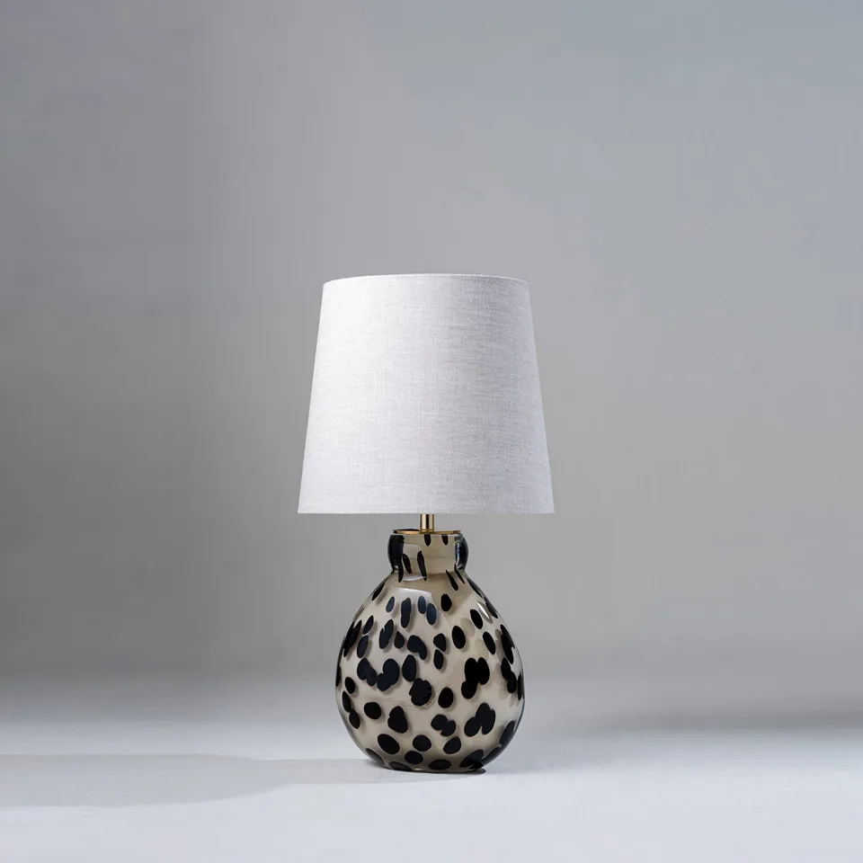 Glass Table Lamp – Handblown Spotted Ottie 50 cm Bedside Accent 1 Glass table lamp with handblown spotted body and grey linen shade on a bedside table