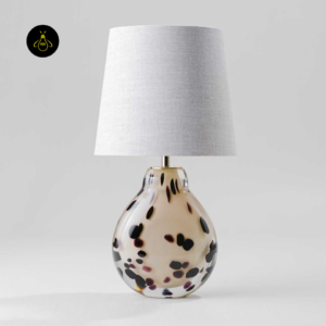 Front view of small table lamp with cream spotted glass body and fabric shade