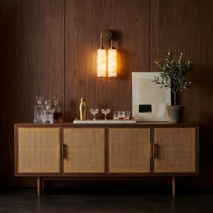 Designer wall light close-up highlighting the layered alabaster pucks and aged brass finish