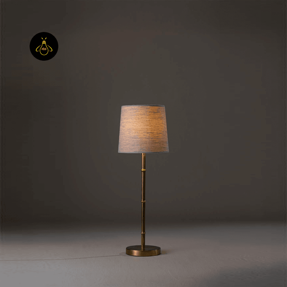 Mini Brass Table Lamp – Slim Bamboo-Stem Design, 53 cm 2 Mini brass table lamp lit to show a warm bedside glow through the linen shade