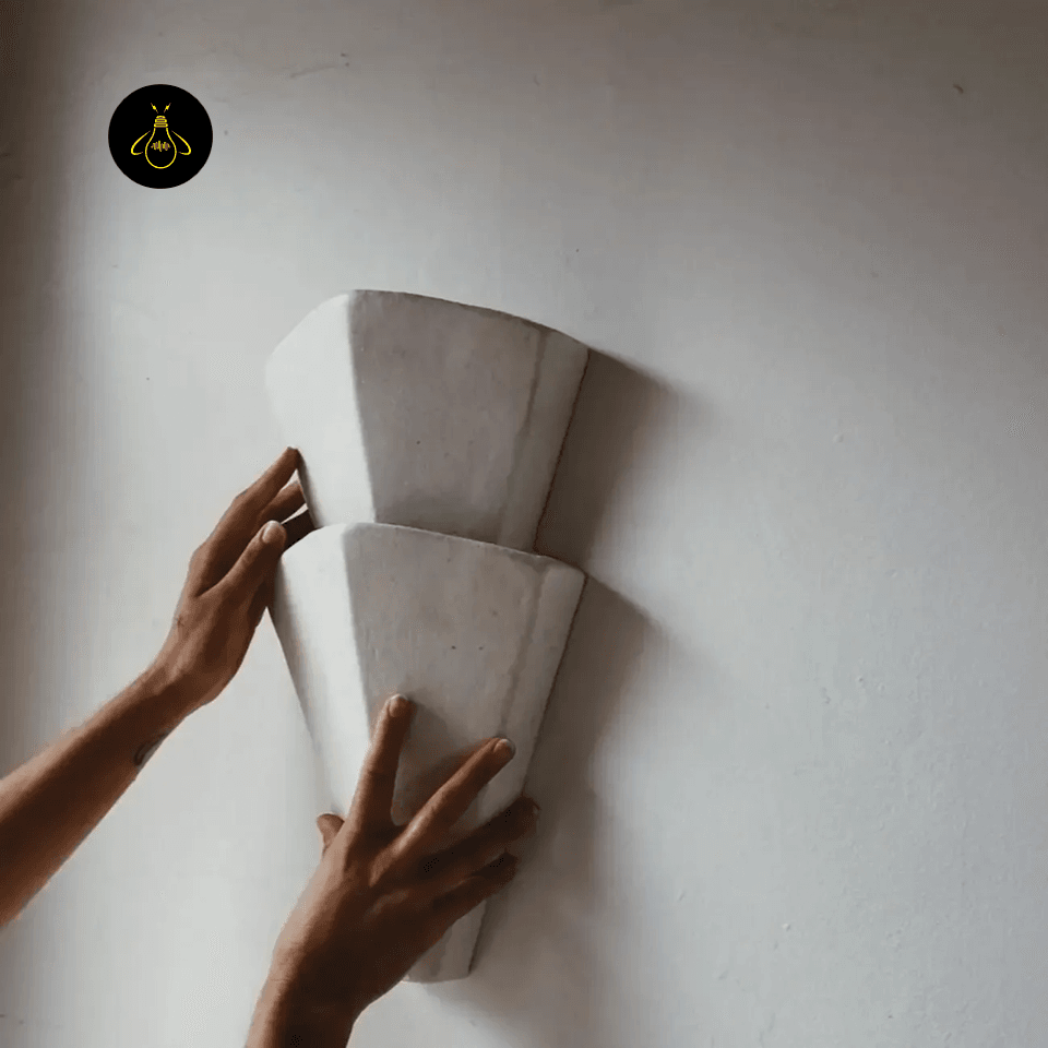 Decorative Wall Light – Textured Tiered Torch Sconce, 44 cm 4 Decorative wall light held to the wall to show its 44 cm scale during installation