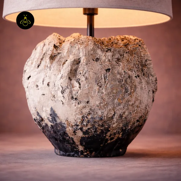 Close-up of the textured weathered ivory and charcoal table lamp vessel base