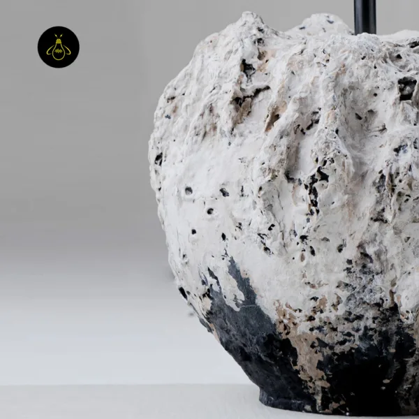 Detail of the hand-finished textured vessel base of the Vela table lamp