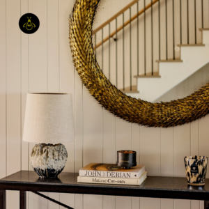 Designer table lamp styled beneath a mirror on a console table