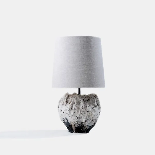Wabi sabi table lamp with a textured sculptural vessel base and linen shade
