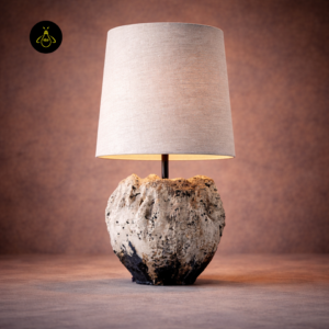 Front view of designer table lamp with sculptural textured base