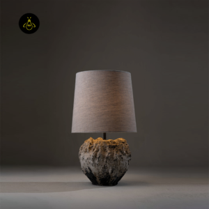 Designer table lamp lit in a styled interior setting