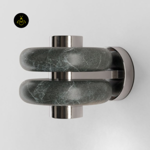 Close-up of modern wall light showing green stone veining and polished metal detailing