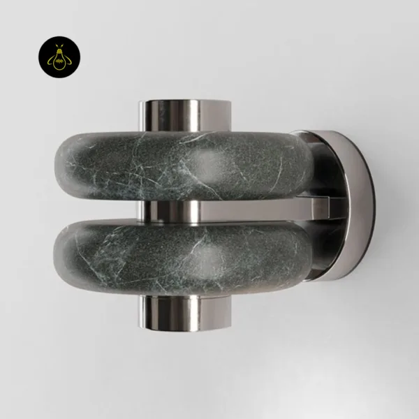 Close-up of the green marble wall light showing white veins on the rounded bands and the round stainless steel backplate