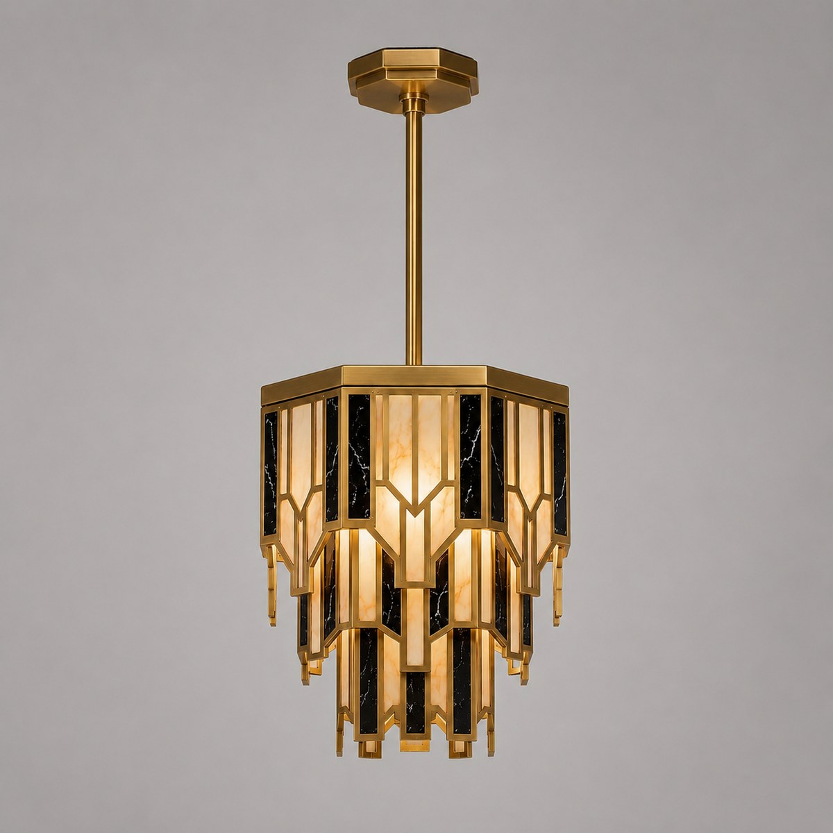 Art Deco brass pendant light with tiered alabaster and black marble-effect panels, lit