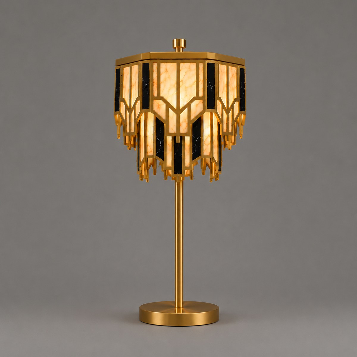 Art Deco brass table lamp with tiered alabaster and black marble-effect shade, lit