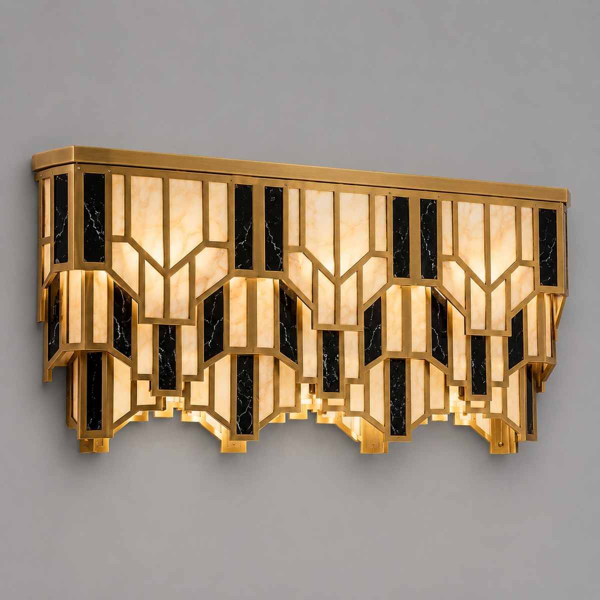 Art Deco brass wall light with tiered alabaster and black marble-effect panels, lit