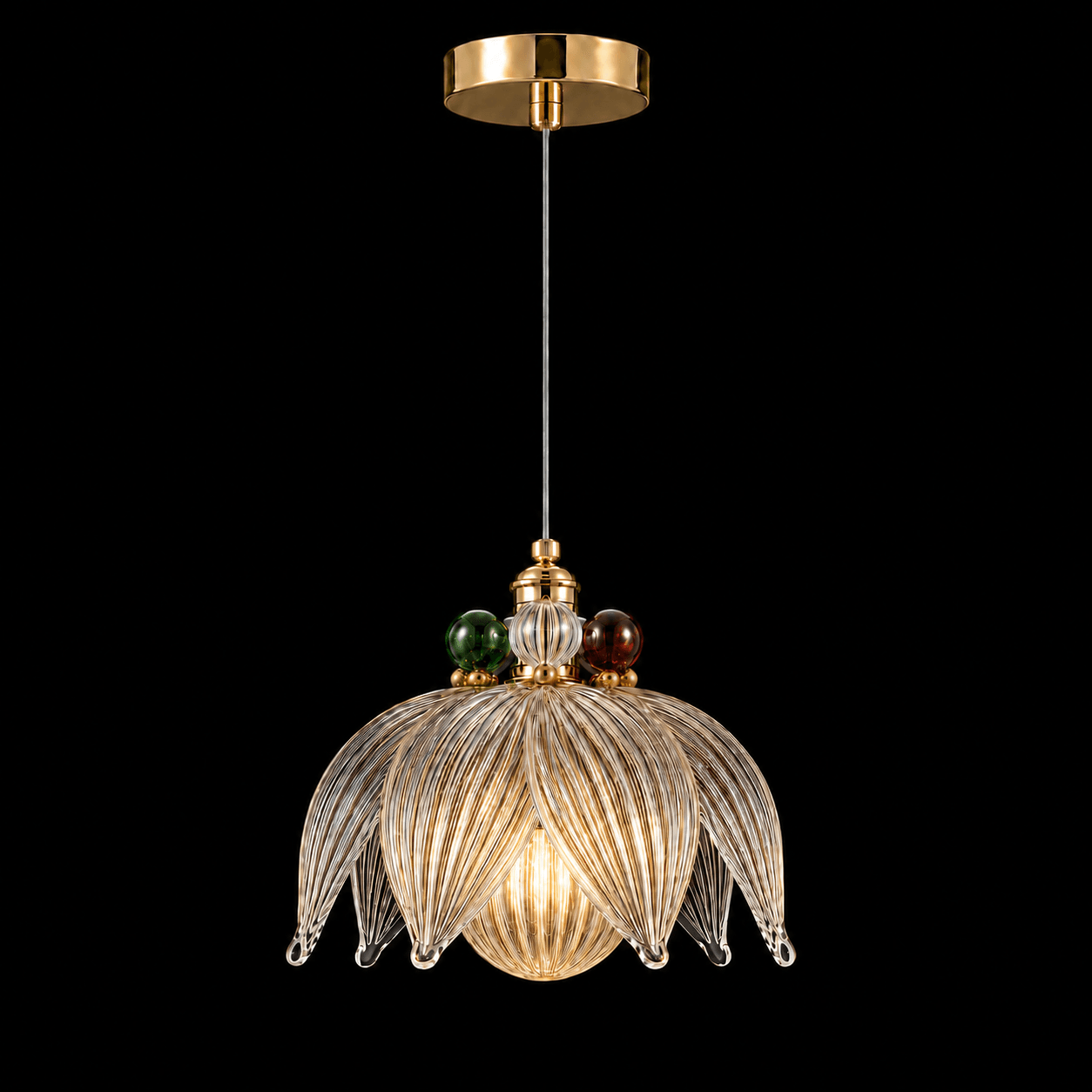 Glass Petal Pendant Light — Ribbed Flower Shade with Coloured Orb Collar 2 Glass petal pendant light on black background lit — ribbed flower-form shade with eight curling glass petals, emerald green and ruby red orbs at collar, warm E27 filament glow