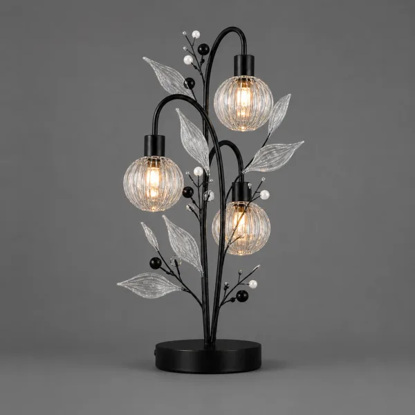 Crystal berry botanical table lamp on grey background lit — black metal branch tree with three ribbed clear borosilicate glass globe cage shades, ribbed glass leaves, matte black and white pearl bead accents