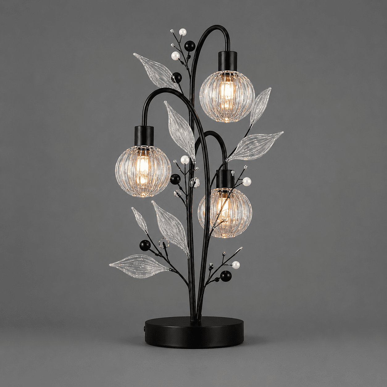 Crystal Berry Botanical Table Lamp — 3-Light Ribbed Glass Globe & Leaf Tree 2 Crystal berry botanical table lamp on grey background lit — black metal branch tree with three ribbed clear glass globe cage shades, ribbed glass leaves, matte black and white pearl bead accents
