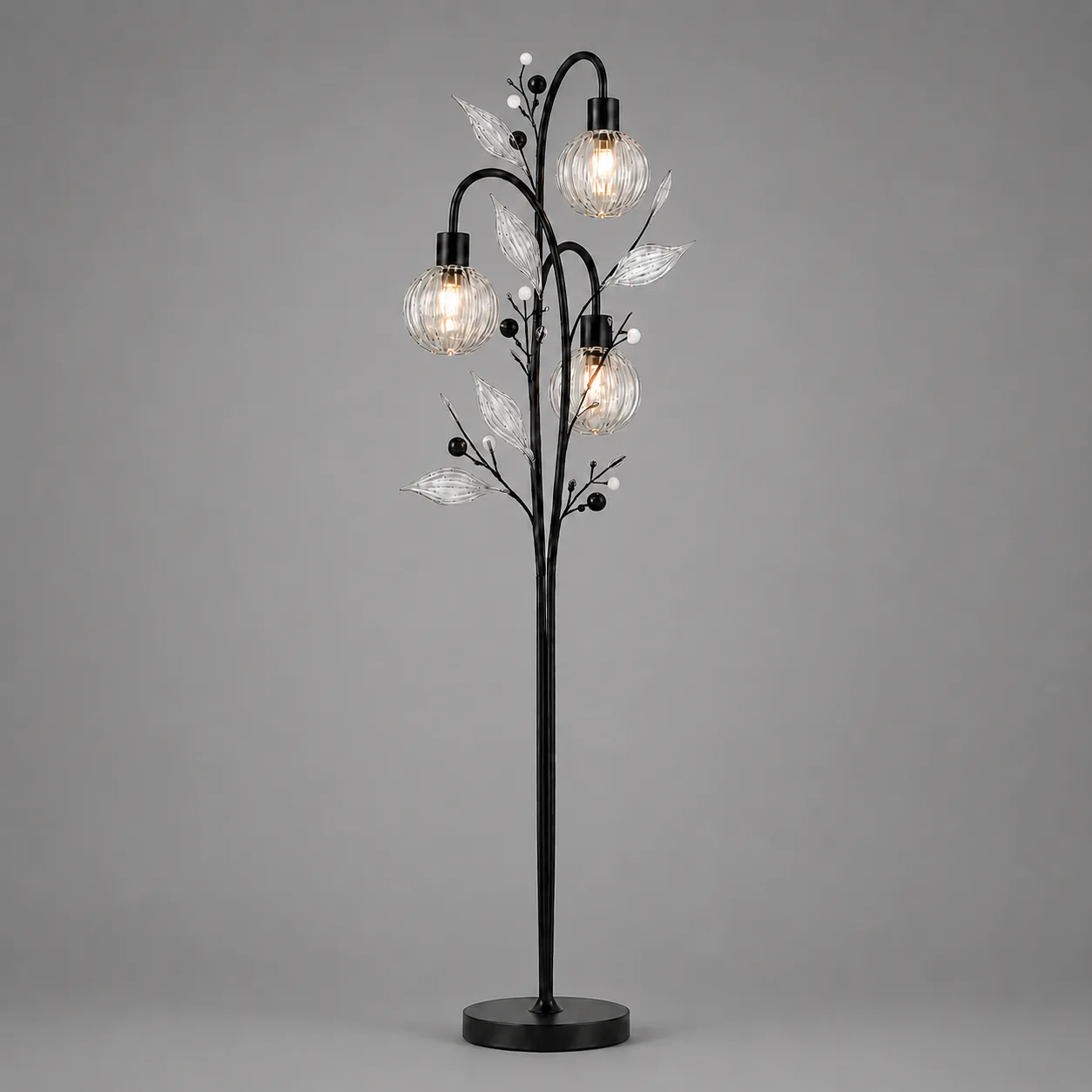 Crystal Berry Botanical Floor Lamp – 3-Light Ribbed Glass Globe Tree 2 Crystal berry botanical floor lamp on grey background lit — black metal tree trunk with three ribbed clear borosilicate glass globe cage shades, clear ribbed glass leaves and matte black and white pearl bead accents