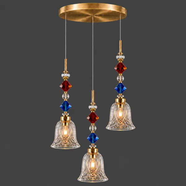 Bell cut light lit on grey: round satin gold stainless steel canopy and three cut borosilicate glass bells at staggered heights
