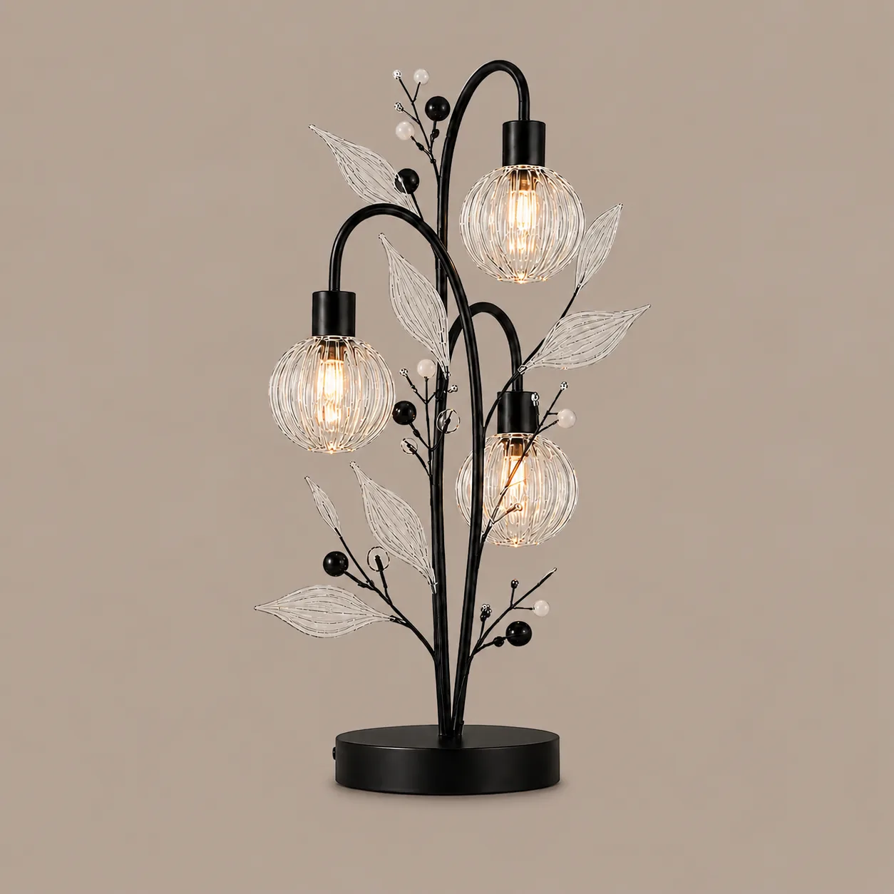 Crystal Berry Botanical Table Lamp— 3-Light Ribbed Glass Globe & Leaf Tree 3 Crystal berry botanical table lamp on warm beige background lit — three ribbed glass globe cage shades on arching black branches with clear borosilicate glass leaves and pearl berry bead accents