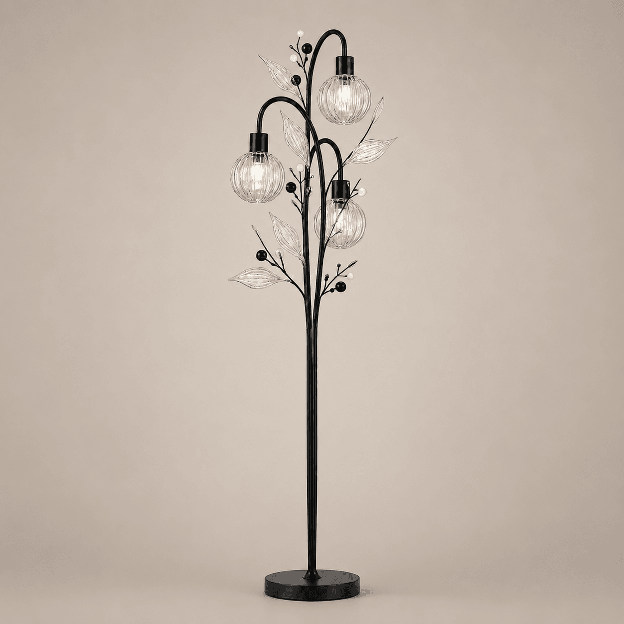 Crystal Berry Botanical Floor Lamp — 3-Light Ribbed Glass Globe & Leaf Tree 4 Crystal berry botanical floor lamp on warm beige background lit — three ribbed glass globe cage shades at different heights on arching black metal branches with clear glass leaves and pearl berry accents