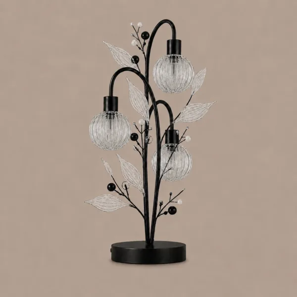Crystal berry botanical table lamp on warm beige background unlit — black metal tree frame with three ribbed glass globe cages, clear ribbed glass leaves, matte black and white pearl beads