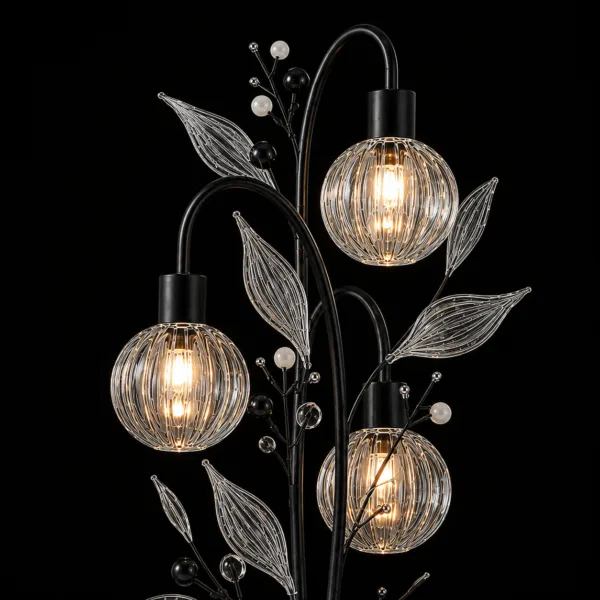 Crystal berry botanical table lamp close-up detail on black background — ribbed glass globe cage shades lit with warm E27 filament, clear ribbed glass leaves and matte black and white pearl bead branch sprays