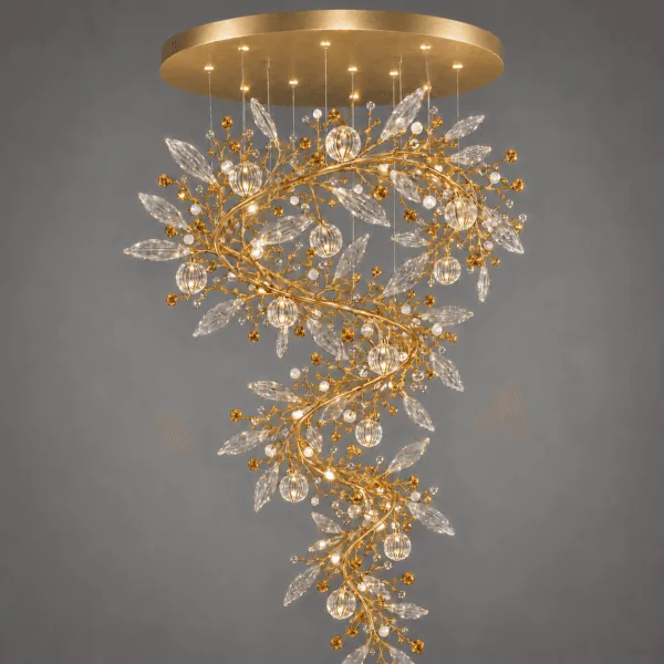 Crystal vine foyer chandelier close-up on grey background — satin gold branches with marquise crystal leaves, pearl-white beads and lit ribbed globe pendants