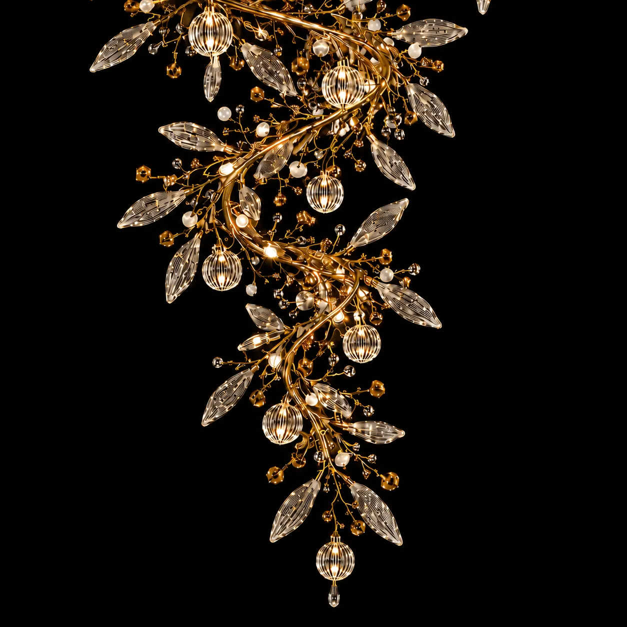 The Crystal Vine — A Sculptural Cascade of Light 6 Crystal vine foyer chandelier lower cascade close-up — ribbed crystal globe pendants and marquise cut-glass leaves glowing on satin gold branches