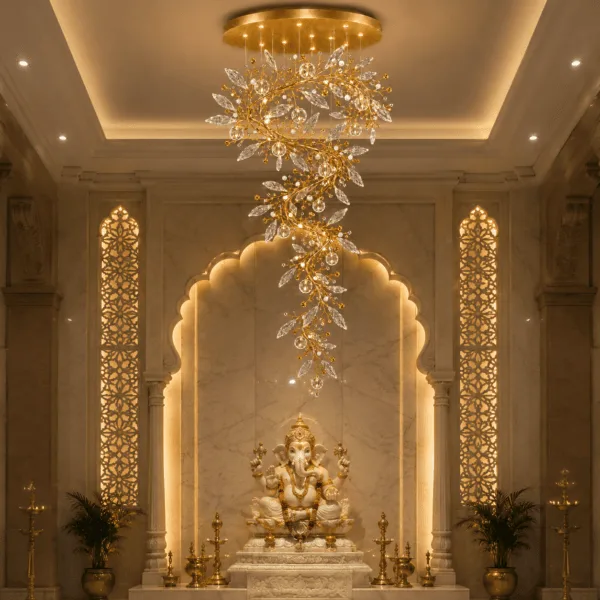 Crystal vine foyer chandelier in temple pooja room — warm glow over marble arch and Ganesha idol, satin gold spiral cascade