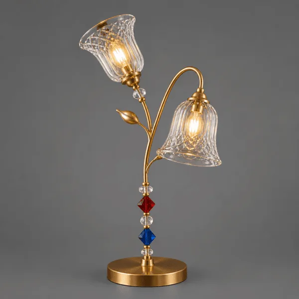 Double glass table lamp on grey background – twin-arm satin gold floral stem with upward and outward-facing cut-glass shades